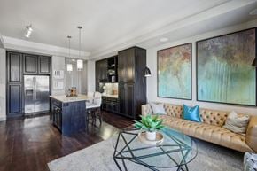 Ft. Worth apartment for rent - A modern kitchen with dark wood cabinets and a glass table.