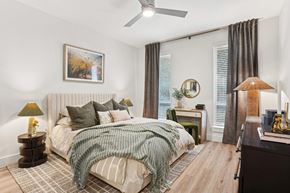 Irving apartment for rent - A bedroom with a large bed and a ceiling fan.