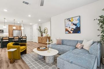 Irving apartment for rent - A living room with a grey couch and a yellow chair.