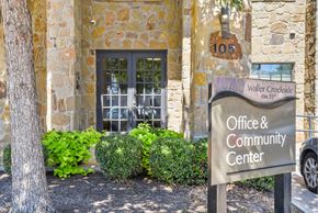 Austin apartment for rent - A sign for the Office & Community Center is in front of a stone building.