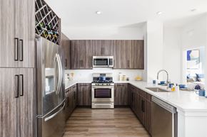 Ridgewood apartment for rent - A modern kitchen with wooden cabinets and stainless steel appliances.
