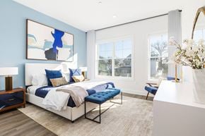 Ridgewood apartment for rent - A bedroom with a large bed and a blue couch.