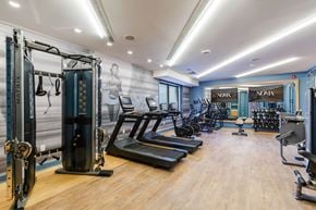 Ridgewood apartment for rent - A gym with a variety of equipment including treadmills, exercise bikes, and weight machines.