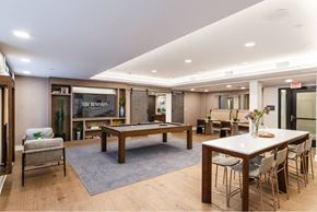 Ridgewood apartment for rent - A room with a pool table and a bar area.