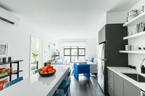 Charlestown apartment for rent - A kitchen with a white counter top and blue chairs.