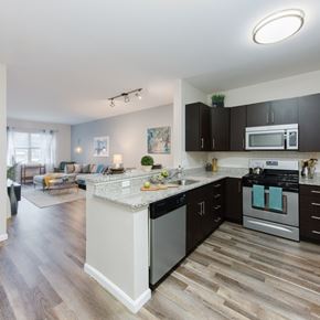 Wilmington apartment for rent - A modern kitchen with dark wood cabinets and a white island.