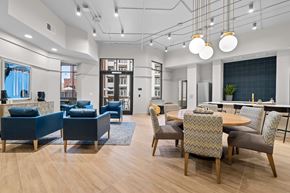 Greenville apartment for rent - A modern dining room with a wooden table and chairs.