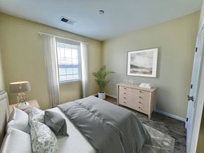 Northampton apartment for rent - Garden-Style Apartments Near Lehigh Valley Mall in Northampton, PA - Residences at Willow Ridge - A Bedroom with Carpet Flooring, and a Nightstand with a Lamp.