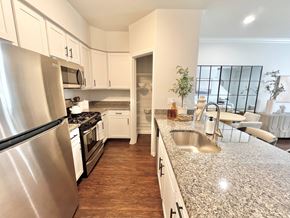Marlton apartment for rent - A kitchen with a stainless steel refrigerator and a granite countertop.