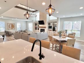 Marlton apartment for rent - A modern kitchen with a large island and pendant lights.