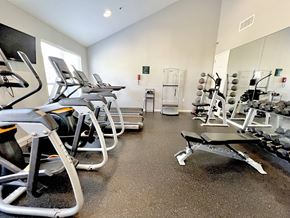 Marlton apartment for rent - A gym with treadmills, exercise bikes, and weightlifting equipment.