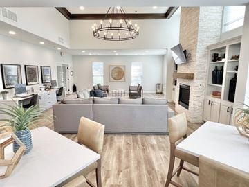 Marlton apartment for rent - A modern living room with a grey sofa and a wooden dining table.