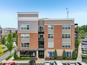 Upper St Clair apartment for rent - A modern two-story building with a parking lot in front.