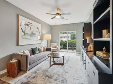 Upper St Clair apartment for rent - A living room with a grey couch, a coffee table, and a painting on the wall.