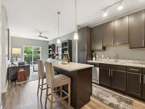 Upper St Clair apartment for rent - A kitchen with brown cabinets and a white island.