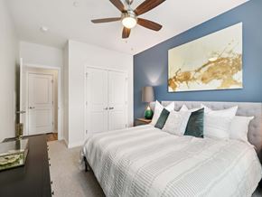 Upper St Clair apartment for rent - A bedroom with a large bed and a ceiling fan.