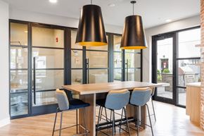 Hawthorne apartment for rent - A modern dining room with a wooden table and grey chairs.