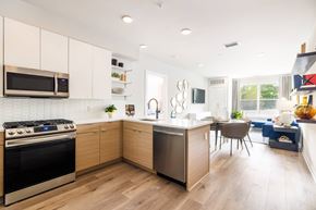Hawthorne apartment for rent - A modern kitchen with wooden cabinets and a stainless steel oven.