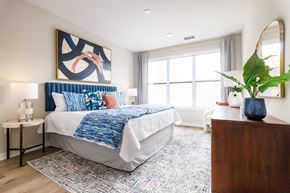 Hawthorne apartment for rent - A bedroom with a large bed and a painting on the wall.