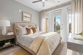 Charleston apartment for rent - A bedroom with a large bed and a ceiling fan.
