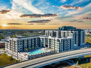 Charleston apartment for rent - A large hotel with a pool is surrounded by a bridge and other buildings.
