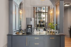 Charleston apartment for rent - A modern kitchen with a dark grey cabinet and a coffee machine on the counter.