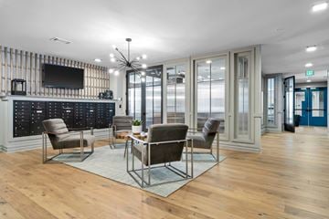 Greenville apartment for rent - A modern living room with a wooden floor and a television on the wall.