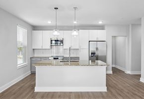 Summerville apartment for rent - A modern kitchen with a central island and pendant lights.