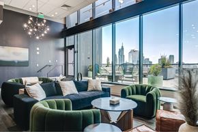 Philadelphia apartment for rent - A modern living room with a view of the city skyline.