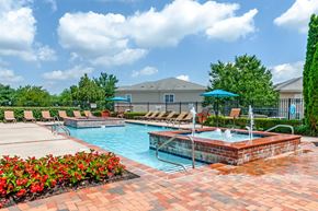 Cherry Hill apartment for rent - Garden-Style Apartments in Cherry Hill, NJ with In-Unit Washer and Dryer - Highlands at Cherry Hill - Sparkling Swimming Pool with Brick Detailing, Relaxing Lounge Chairs, Umbrellas, and a Hot Tub with Bubbling Water Jets.