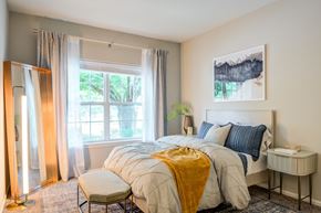 Cherry Hill apartment for rent - A bedroom with a large bed and a window with curtains.
