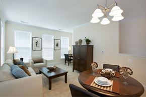 Fairfax apartment for rent - A modern dining room with a wooden table set for two.