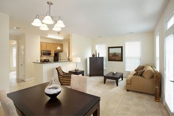 Fairfax apartment for rent - A well-lit living room with a brown table and a brown couch.