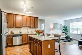 Mt. Laurel apartment for rent - A kitchen with wooden cabinets and a refrigerator.