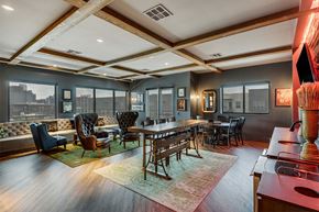 Dallas apartment for rent - A modern room with a long table and chairs at The Academic in Dallas Texas