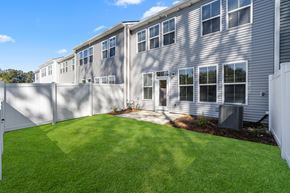 Summerville apartment for rent - the back of a house with a yard and a fence