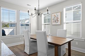Summerville apartment for rent - a dining room with a wooden table and chairs and windows
