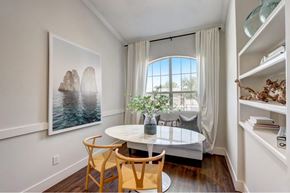 Dallas apartment for rent - a dining room with a large window and a table with chairs