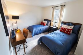 Dacula apartment for rent - A bedroom with two beds and a desk.