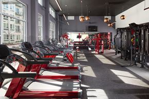 Austin apartment for rent - a row of red exercise bikes in a gym