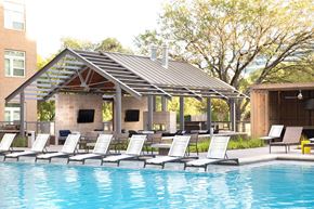 Austin apartment for rent - swimming pool with lounge chairs and a pool house with a pool