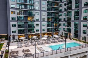 Nashville apartment for rent - A large building with a pool in front of it.