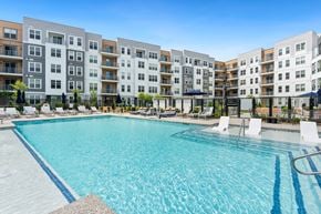 Medway apartment for rent - A large swimming pool in front of apartment buildings.