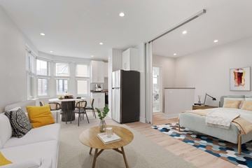Chicago apartment for rent - A modern living room with a white sofa and a wooden coffee table.