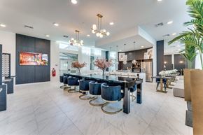 Hutto apartment for rent - A modern dining room with a long table and chairs.