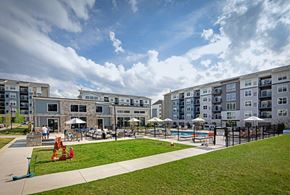 Cranberry Township apartment for rent - A large building with a pool in front of it.