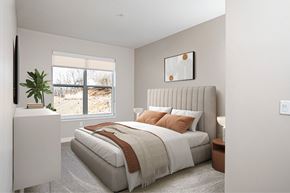 Cranberry Township apartment for rent - A bedroom with a large bed and a window overlooking a beach.