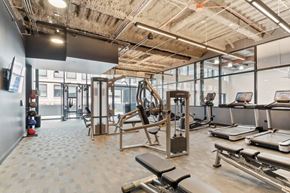 Chicago apartment for rent - A gym with a variety of equipment including treadmills, weights, and exercise machines.