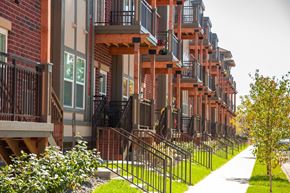 Osseo apartment for rent - A long row of red brick apartment buildings with balconies.