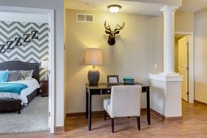 Osseo apartment for rent - A bedroom with a bed, desk, and chair.